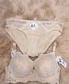 Crafted from a delicate, intricate floral lace pattern that covers the full cups, the wide under-bust band, and the matching panties. The lace is soft to the touch and high-quality.